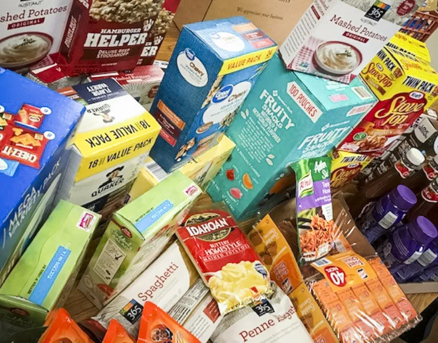 Boxes of food sit on a table.