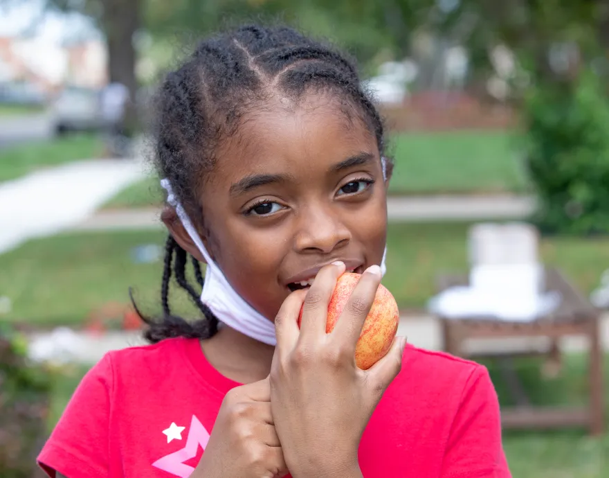 Girl eating fruit during Coronavirus shutdowns