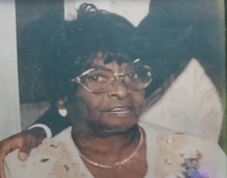Old picture of older black woman with white dress and glasses
