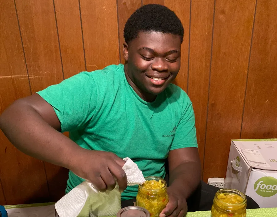 Young man canning food