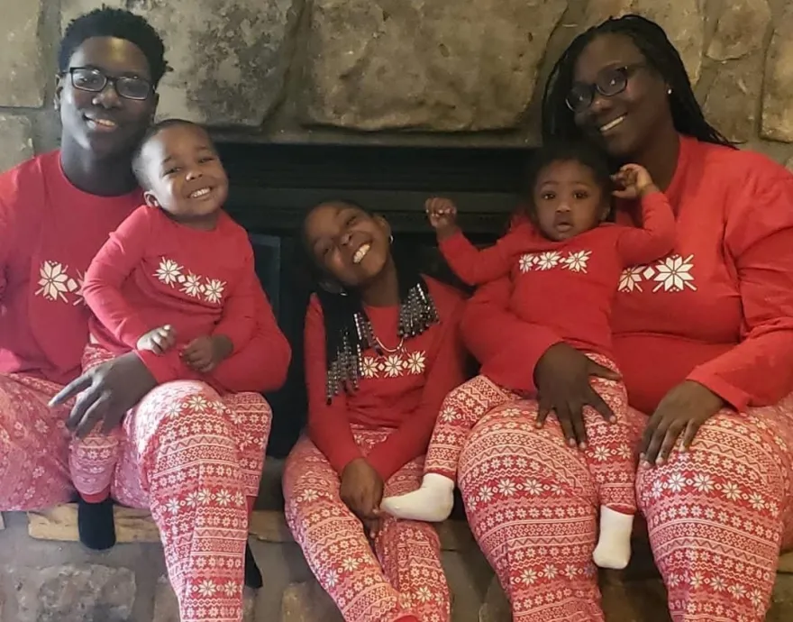 Family of 5 wearing matching PJ's