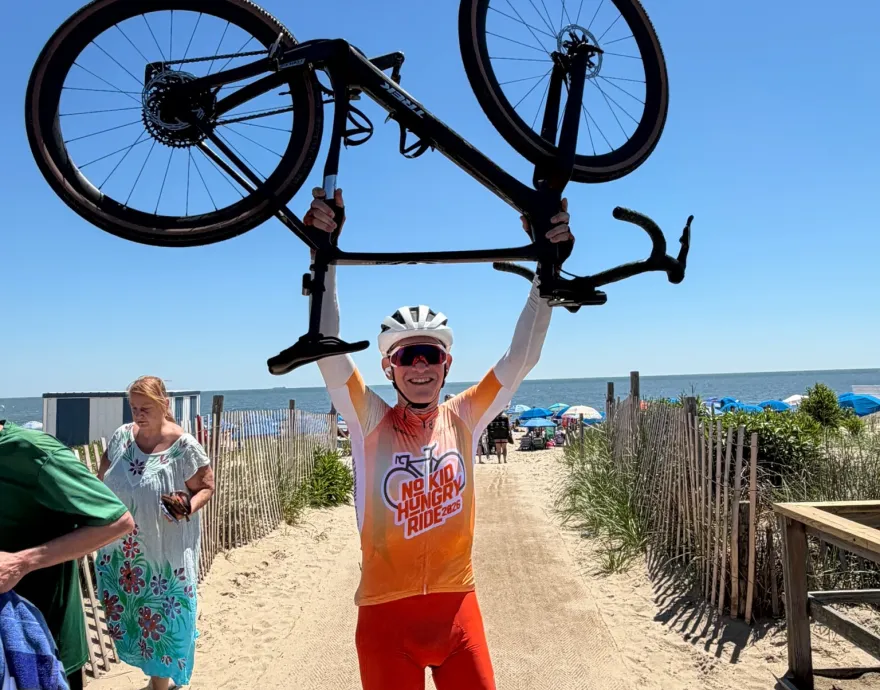 Man holding bike in air