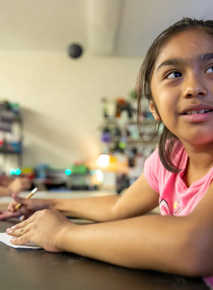 Latino girl in classroom paying attention