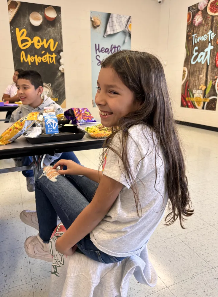 Girl Smiling in Cafeteria