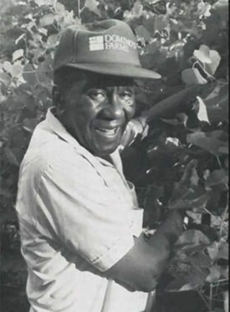 B&W portrait of Booker T. Whatley on farm