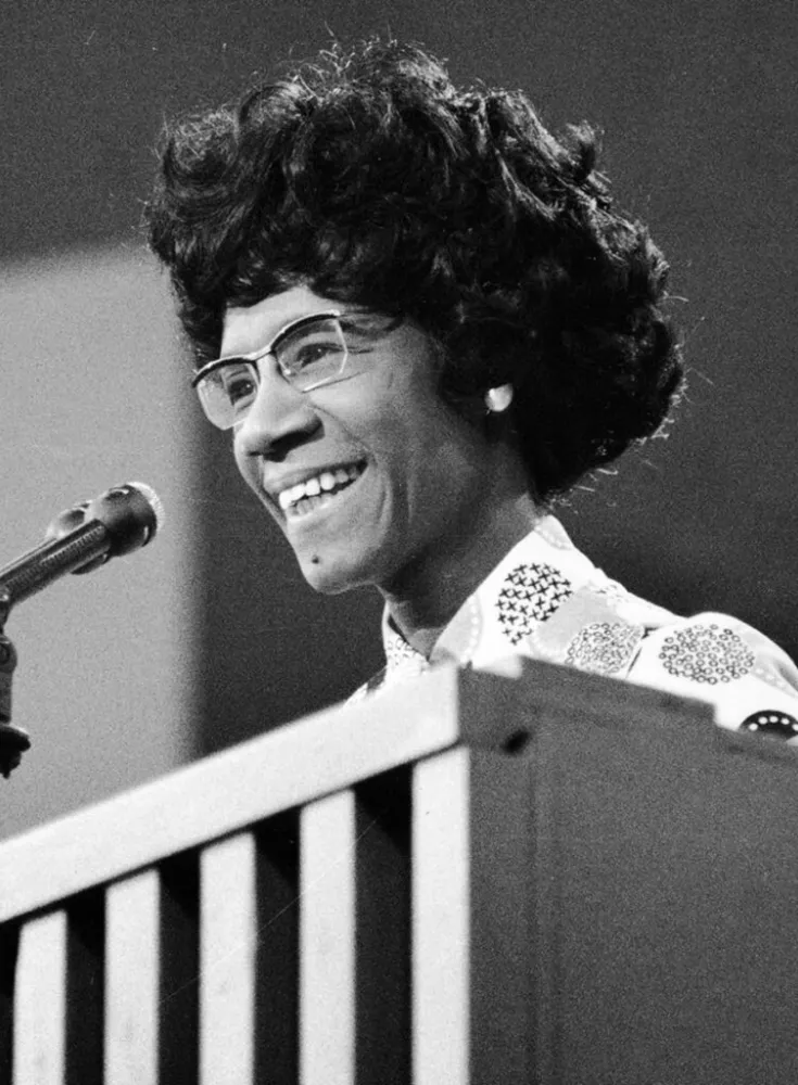 B&W photo of Shirley Chisholm speaking at podium
