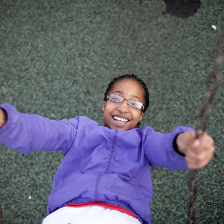 Girl swinging looking up