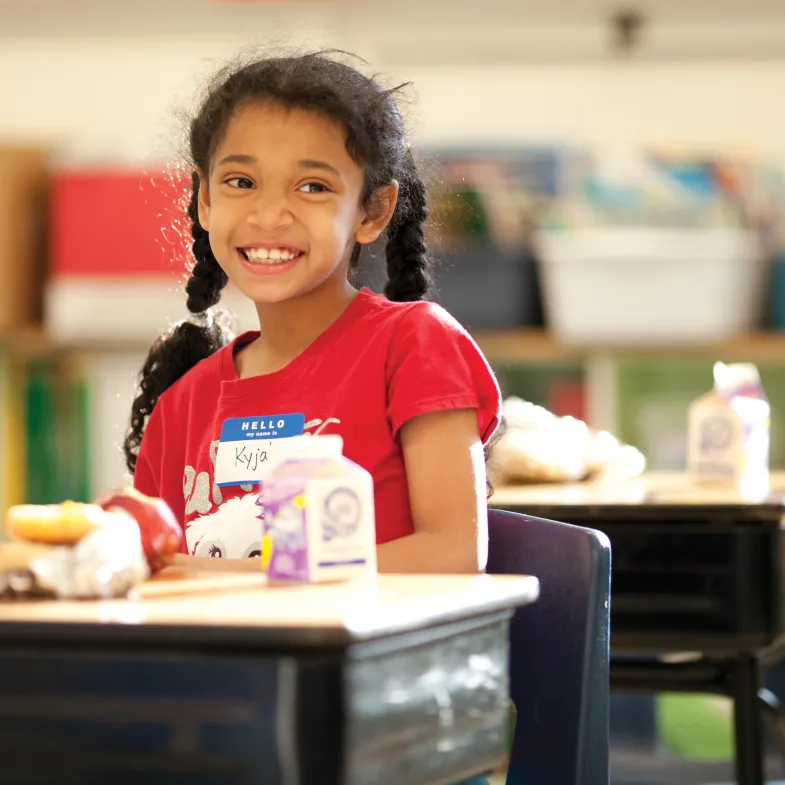 Girl Eating Breakfast at Desk