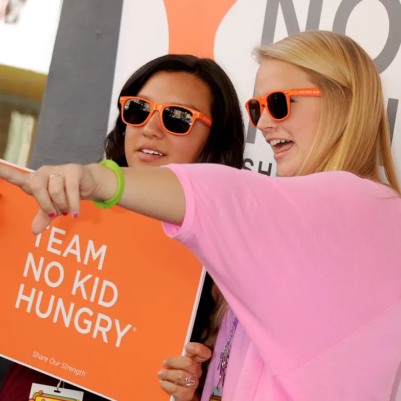 Girls Holding a Sign