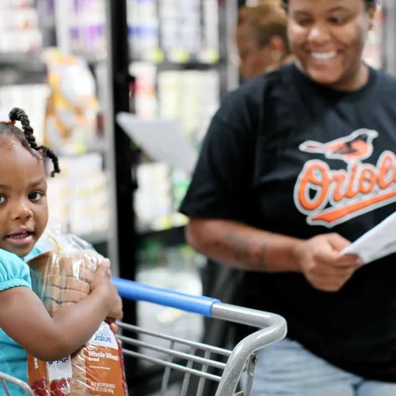 mom and child shopping at grocery store