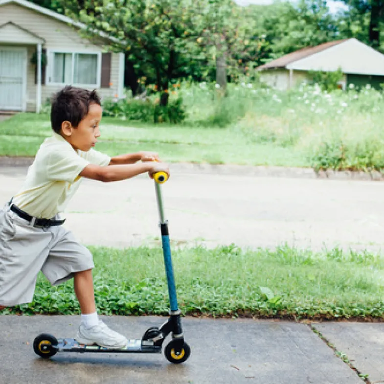 Boy riding on scooter