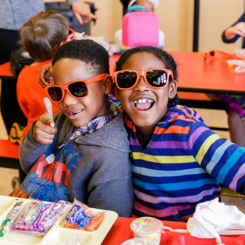 Happy kids wearing No Kid Hungry sunglasses
