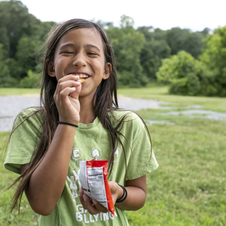 girl eating in a rural community