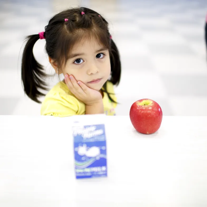 Sad girl with apple and milk