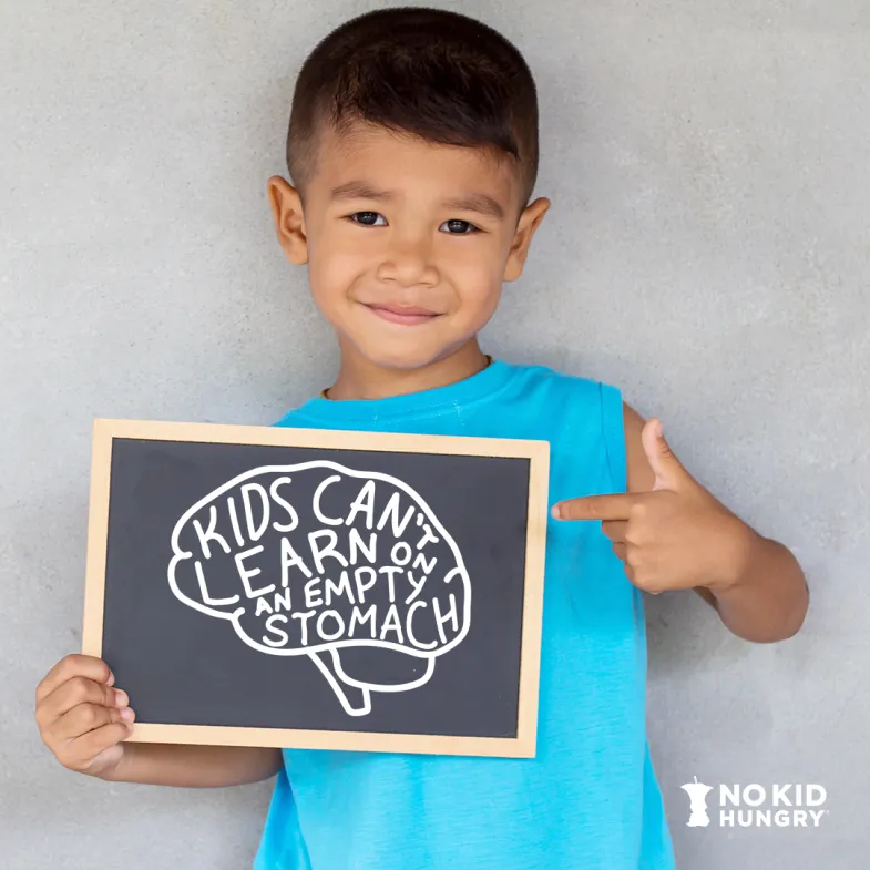 Boy with Kids Can't Learn on An Empty Stomach Chalk Art in shape of a brain.