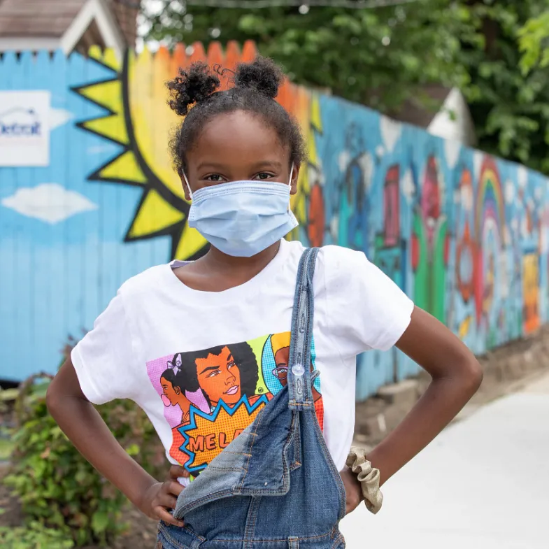 Black girl wearing as mask with hands on hips