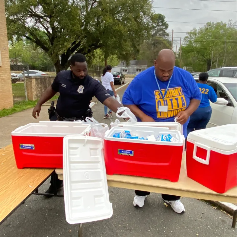 Men putting food in coolers