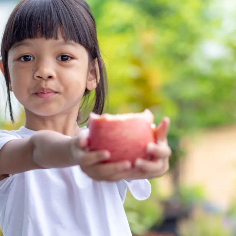 Girl holding apple