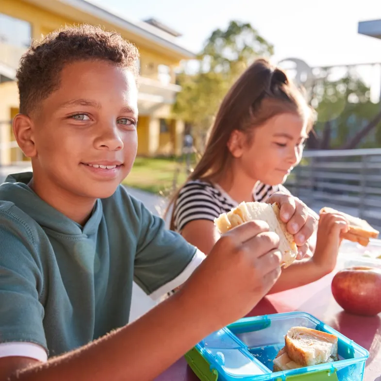 Boy and girl eating breakfast