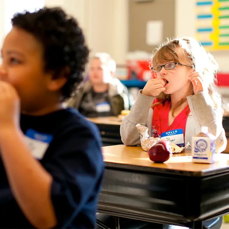 Kids eating breakfast at desks