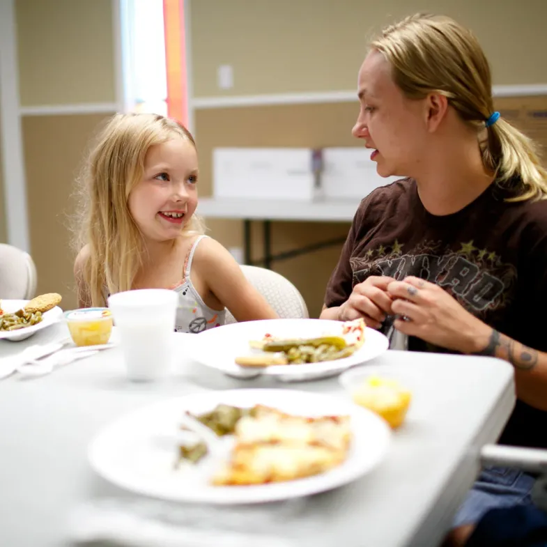 Child eating lunch with mother