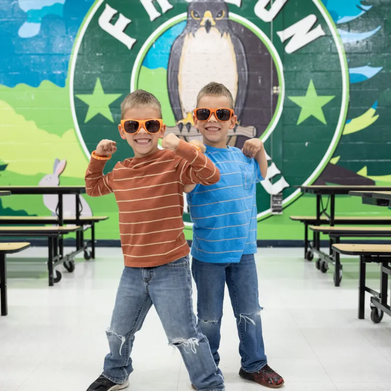 Twin white kids wearing sunglasses