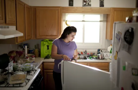 Woman looking into refrigerator