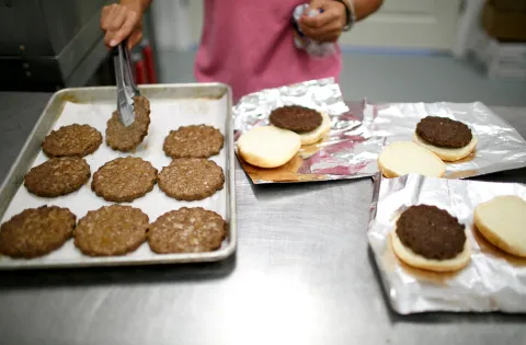 Hamburgers being prepared in an industrial kitchen