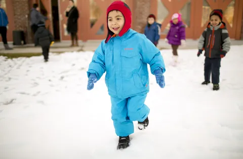 boy running in the snow