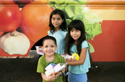 Kids at a free summer meals truck.