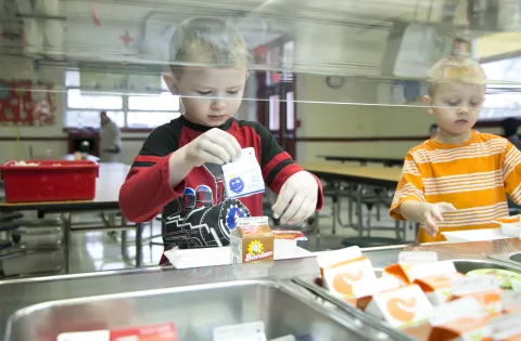 boys getting breakfast in the cafeteria