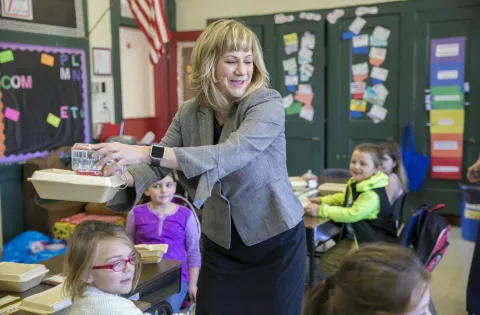 Pam Davis serving breakfast in the classroom