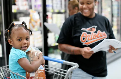 mom and child shopping at grocery store