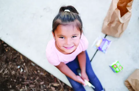 Little girl eating a summer meal.