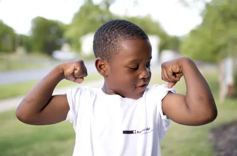 Boy flexing his muscles