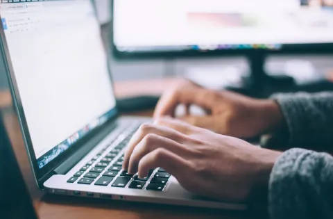 Someone using a laptop [stock image]