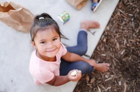 Little girl eating snack