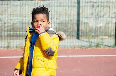 A little boy eating an apple