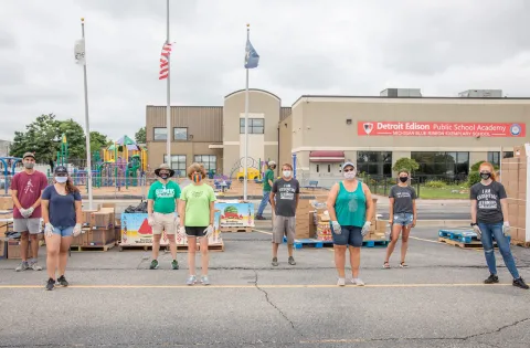 Volunteers wearing masks in a food distribution site