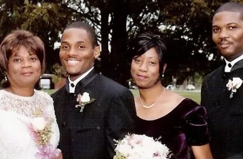 Wedding picture of man and woman accompanied by other two family members (another man and women)