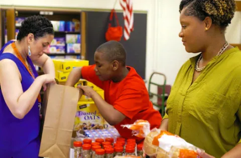 Woman in green serving meals