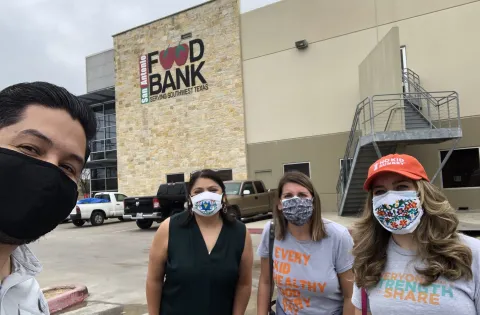 4 masked people in front of food bank
