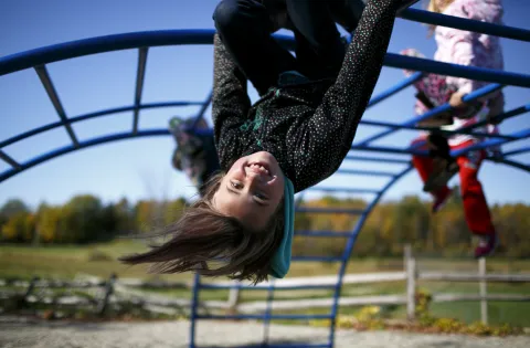 Girl upside down on climbing park