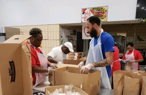Cafeteria staff packing meals