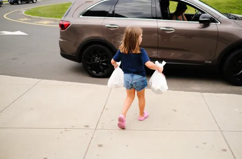 Girl carrying bags