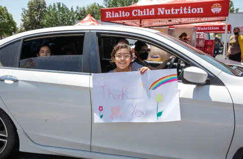 California kid in car with thank you sign