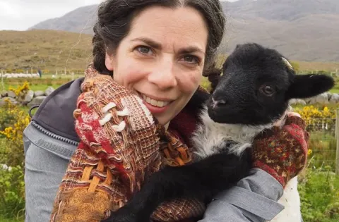 Laura Nelkin holding baby sheep