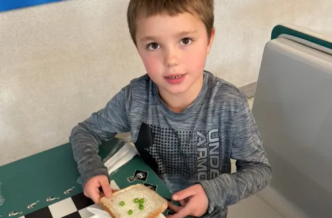 White young kid eating lunch