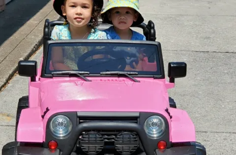 Girls in small pink truck