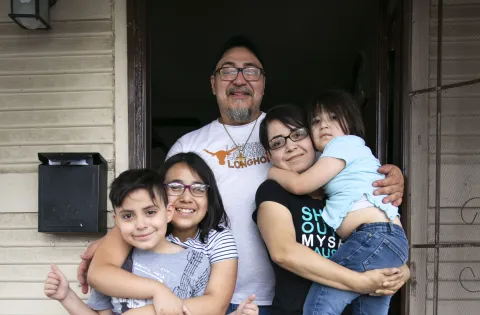 Gonzales family in front of their home